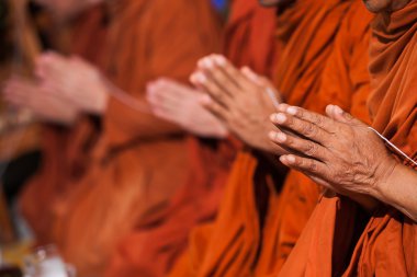 Hands of a monk praying to blessed bride and groom in Thai's wedding clipart
