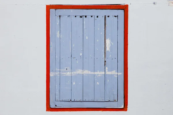 Window with blue shutters on a white wall. — Stock Photo, Image