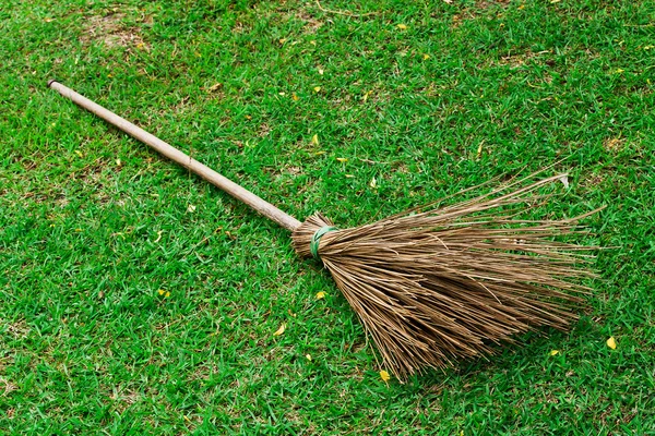 Broom on green grass in the garden — Stock Photo, Image