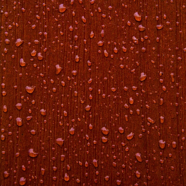 Abstract raindrops pattern on red wooden board — Stock Photo, Image