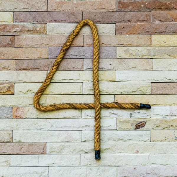 Rope Number four Alphabet on stone background — Stock Photo, Image