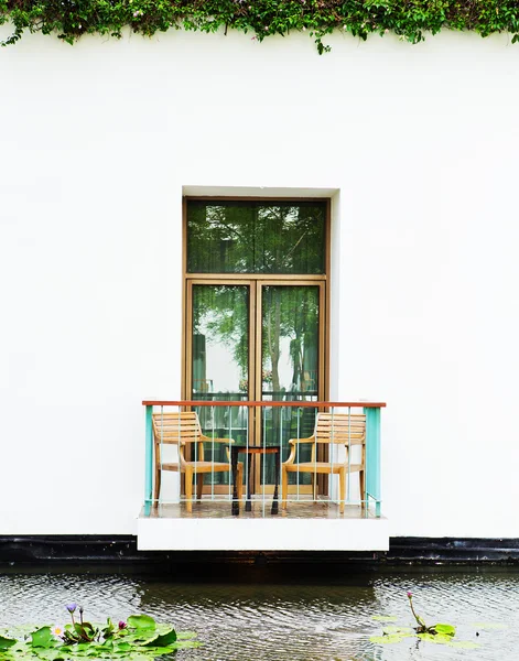 Wooden chair on a lotus pond. — Stock Photo, Image