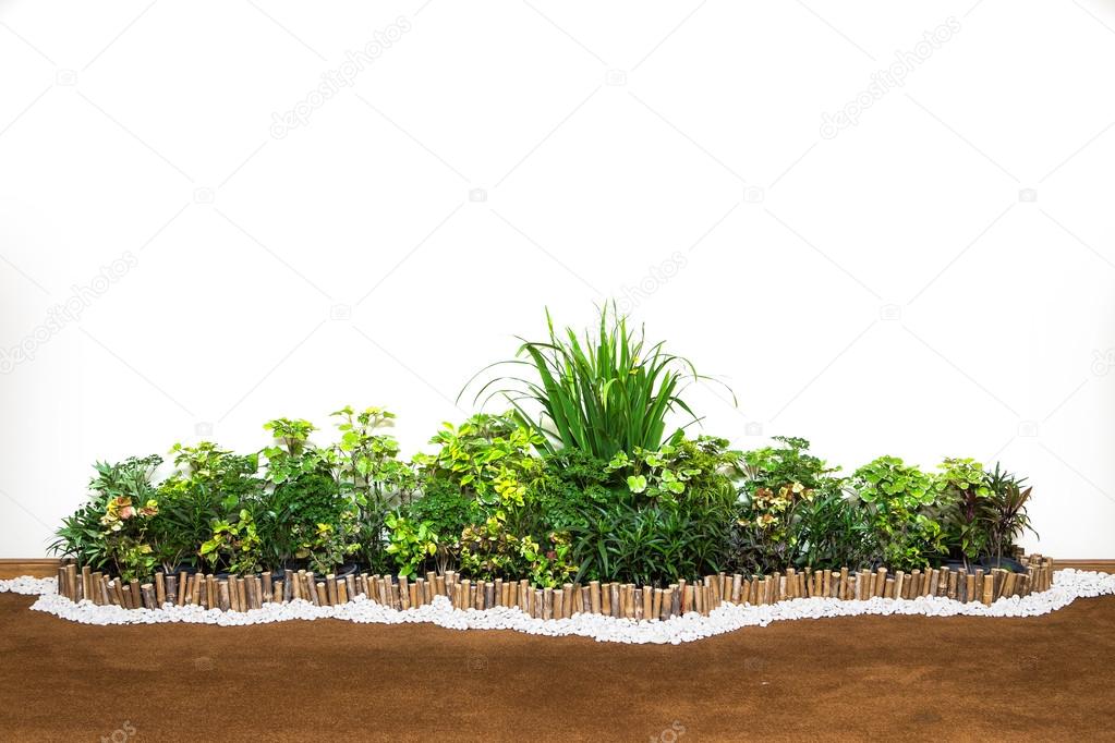 Decorative garden on a cobblestone wall isolated on white backgr