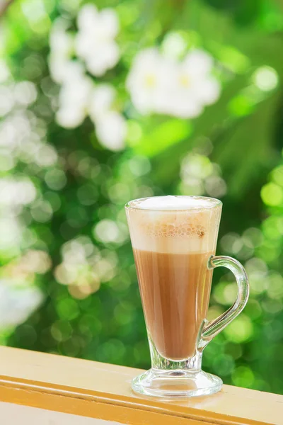 Coffee with pattern in a white cup on wooden background — Stock Photo, Image