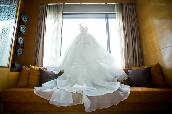 White Wedding dress hanging on a shoulders — Stock Photo, Image