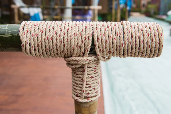 Rope tied knot at bamboo wood