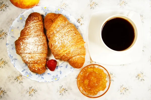 Croissant and cup of coffee — Stock Photo, Image