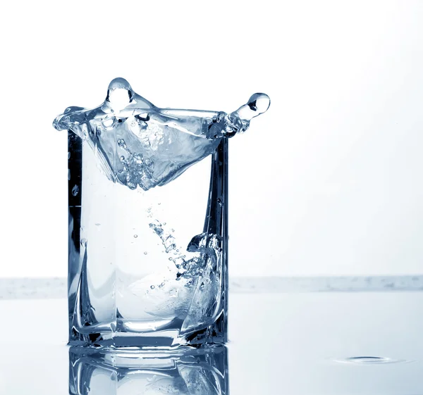 Water and ice cubes in a tall glass — Stock Photo, Image