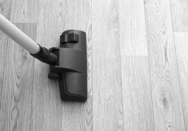 Vacuum cleaner on wooden floor — Stock Photo, Image