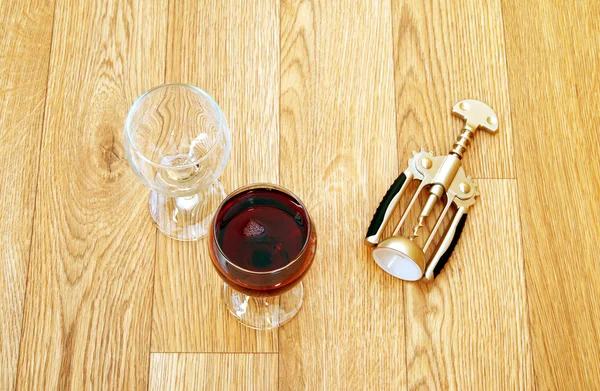 Empty glass and glass of wine and corkscrew — Stock Photo, Image