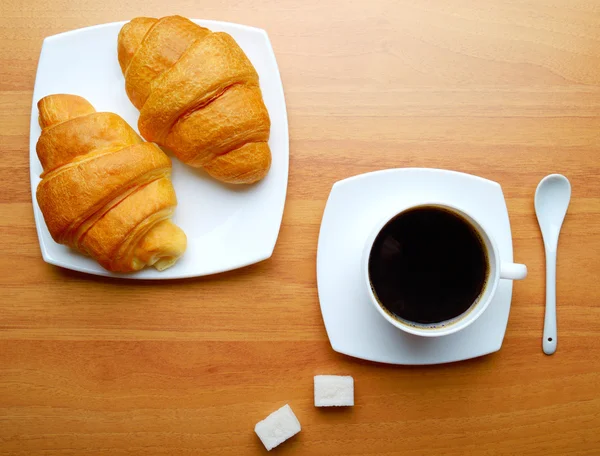 Coffee with pieces of sugar and croissants — Stock Photo, Image