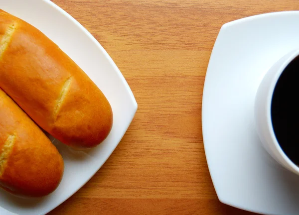 French buns with cup of coffee — Stock Photo, Image