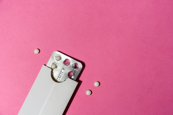 Birth control pills in everyday use case on pink