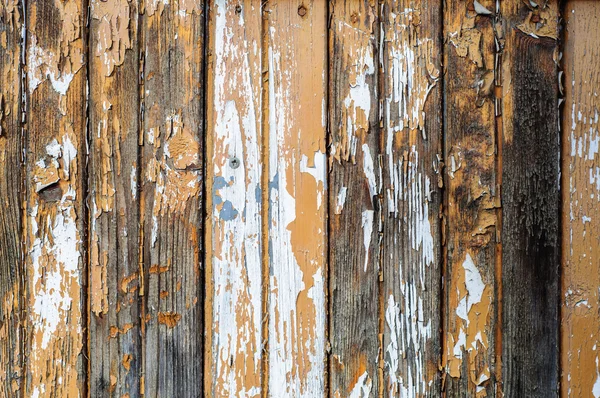 Old rustic wooden wall with cracked paint