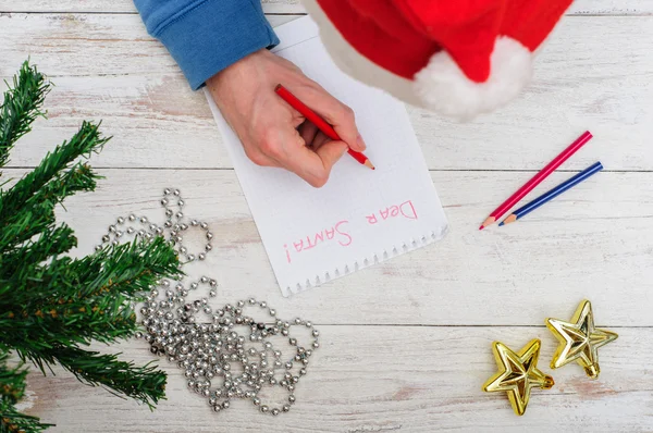 Man writing letter to Santa in Christmas situation
