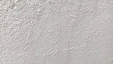 Beyaz krem bir duvarın yüzey dokusu ya da pürüzlü, kaba taneli alçı..