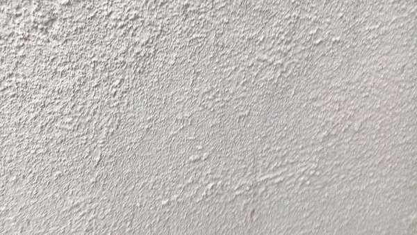 Beyaz krem bir duvarın yüzey dokusu ya da pürüzlü, kaba taneli alçı..