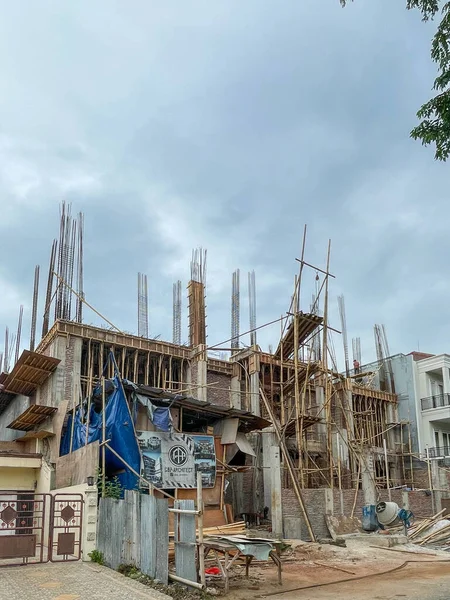 Wooden structure and bamboo formwork on a residential building construction site.