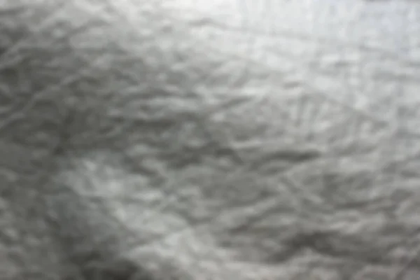 The abstract background is out of focus. View of a calm canal with tree reflections on the water, featuring cube-shaped concrete pillars and a floating pontoon on the water's edge.