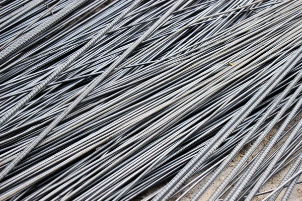 Stack of ribbed steel reinforcement bars (rebar), ready for building construction.