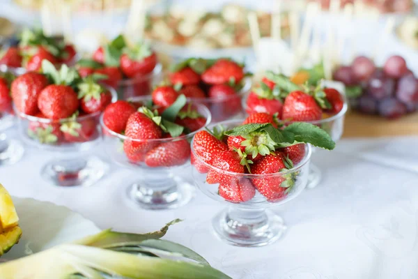 Strawberries in a glass bowl on the white table — Stock Photo, Image