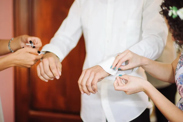Жених застегивает запонку перед свадьбой — стоковое фото