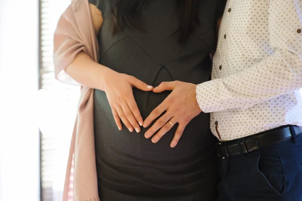 Lovely couple hands show hearth pregnant — Stock Photo, Image