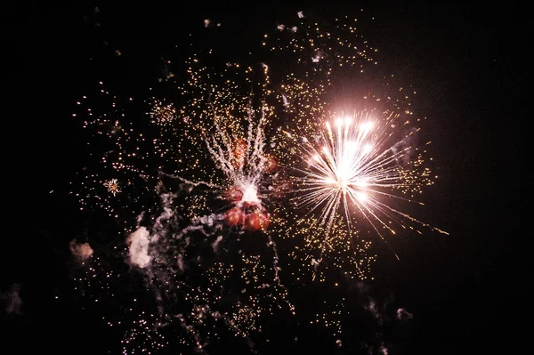 Cluster of colorful fireworks against dark sky — Stock Photo, Image