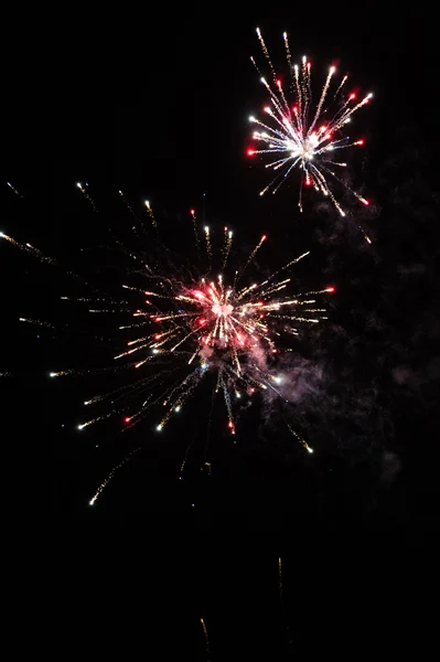 Cluster of colourful fireworks against dark sky — Stock Photo, Image
