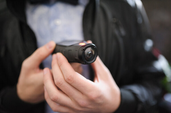 Closeup of a mini video camera held in hand