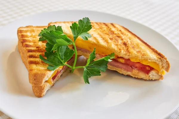 Grilled panini sandwiches stuffed with ham and cheese — Stock Photo, Image