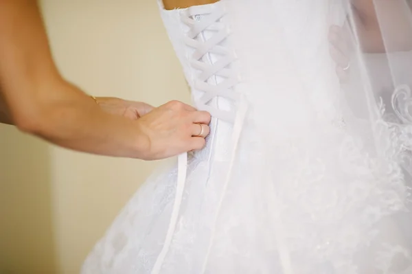 Bride getting dressed on her wedding day — Stock Photo, Image