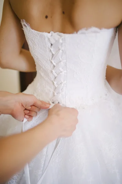 Bride getting dressed on her wedding day — Stock Photo, Image