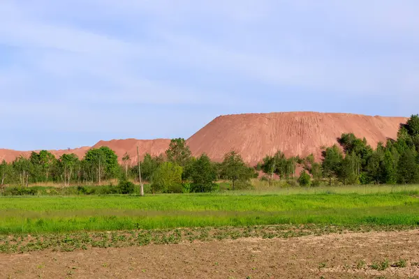 open pit for mining red granite in spring