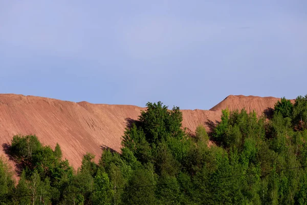 open pit for mining red granite in spring