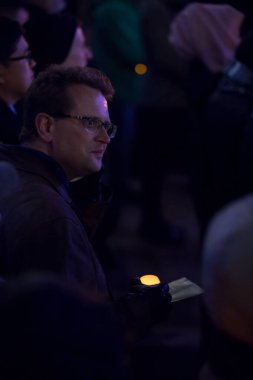 Toronto Yahudi Cemaati nöbeti sırasında Mel Lastman Meydanı 'ndaki Pittsburgh Sinagog Katliamı kurbanları için mum tutan adam., 