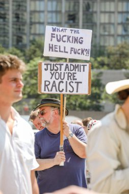 Protesters holding sign that reads, 