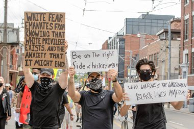 TORONTO, ONTARIO, CANADA - JUNE 6, 2020: Anti-Racism March, in solidarity with Black Lives Matter and against the death of George Floyd and police injustice. clipart