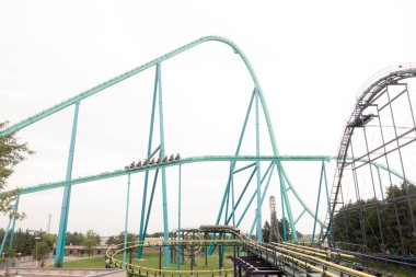 VAUGHAN, CANADA - AUGUST 28, 2018: Dragonfire Double Looper roller coaster at Canada's Wonderland. clipart