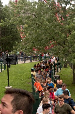 VAUGHAN, CANADA - AUGUST 28, 2018: People wait in line for Leviathan roller coaster at Canada's Wonderland. clipart