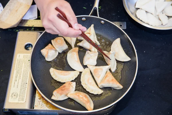 Primo Piano Della Mano Maschile Con Bacchette Che Friggono Gnocchi — Foto Stock