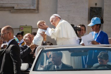 Yeni doğmuş bir bebek Papa Francis kucaklayan