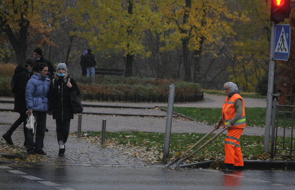A utility worker cleans water intake grates, in Kiev, November 15, 2020
