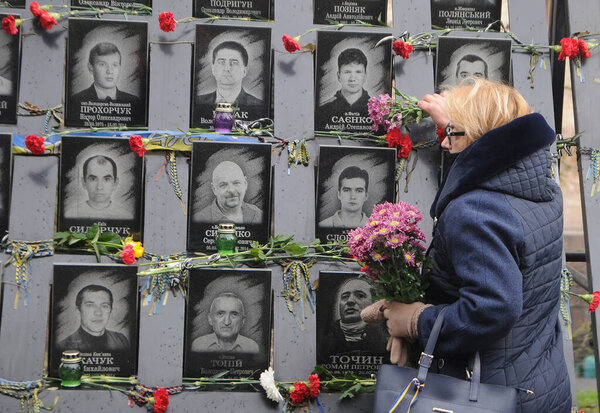 Laying flowers at the portraits of the fallen Heroes of the Heavenly Hundred on the Alley of Heroes of the Heavenly Hundred, on the Day of Dignity and Freedom, in Kiev, November 21, 2020