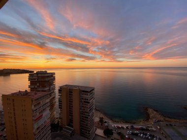 İspanya 'da bulutlarla kumsalda güzel ve renkli bir gün doğumu