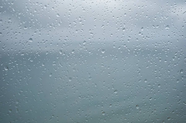 raindrops on window panes, background with space to write. view