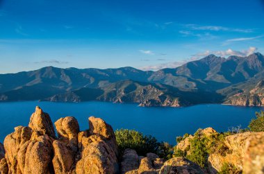 Panoramic view of the Gulf of Porto with rocks in the foreground, Corsica. High quality photo. Copy Space for characters or letters. clipart