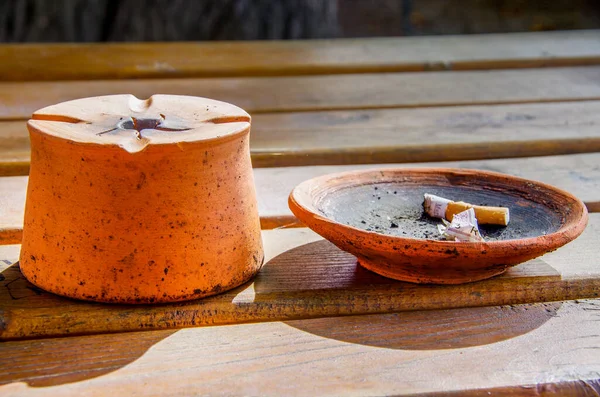 Ashtray made of clay with cigarette butt. High quality photo