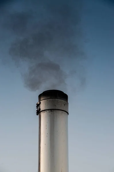 Smoking stainless steel chimney in front of morning sky — Stock Photo, Image