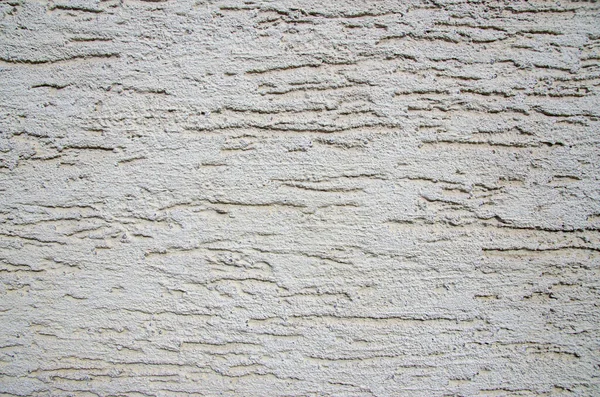 rough plaster facade painted white as a texture or background